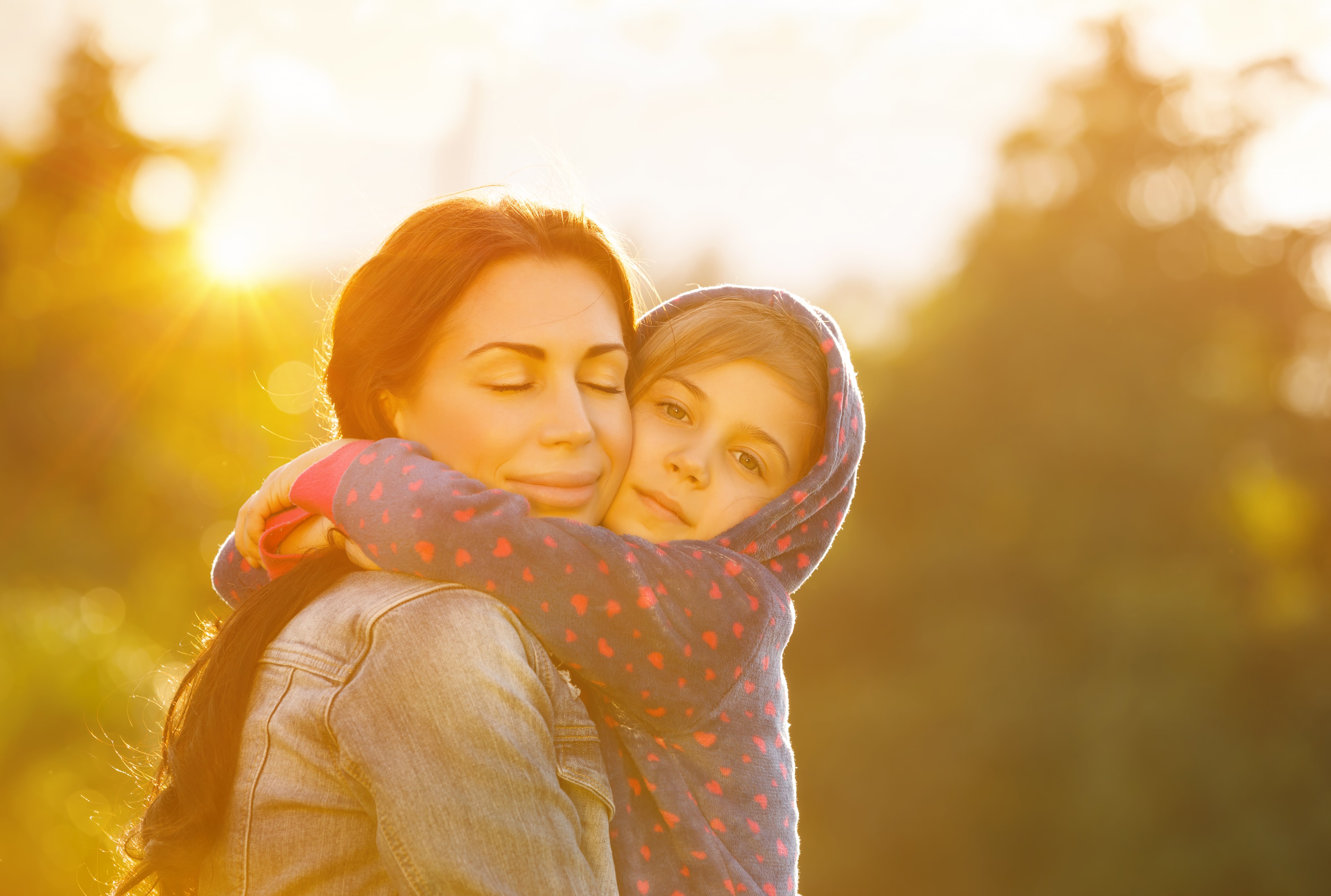 A child and parent in a warm embrace, illustrating emotional safety and connection